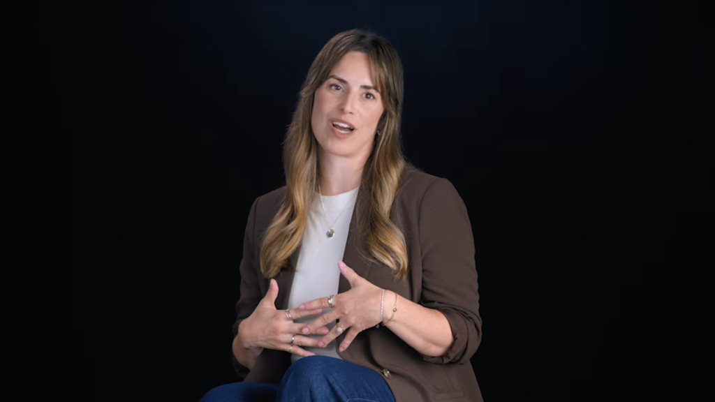 A patient in a brown blazer shares her story against a black backdrop, Victoria Park Medispa – Confidence Shows campaign