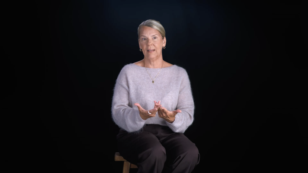 A grey-haired patient in a lilac sweater shares her story against a black backdrop, Victoria Park Medispa campaign